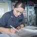 USS America Sailor plots on the Bridge