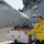Aviation Boatswain's Mate 1st Class Shawn Conway gives hand signals while Sailors move a harrier aircraft on the flight deck of the amphibious assault ship USS Bataan (LHD 5).