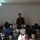 Crisis Response Marines conduct Intelligence training with Ghanaian Forces A person in US Marine Corps digital camouflage uniform stands at the front of a computer lab classroom, appearing to instruct a group of students wearing military/naval uniforms. The students are seated at workstations equipped with desktop computers, monitors, and headsets. The setting appears to be a military training facility, likely in an African country based on the visible uniforms and context.