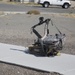 A staged Implemented Explosive Device is removed from the scene by deputies from the San Bernardino County Sheriff's Office using a remote controlled robot during training exercises aboard Marine Corps Logistics Base Barstow, Calif., July 26.