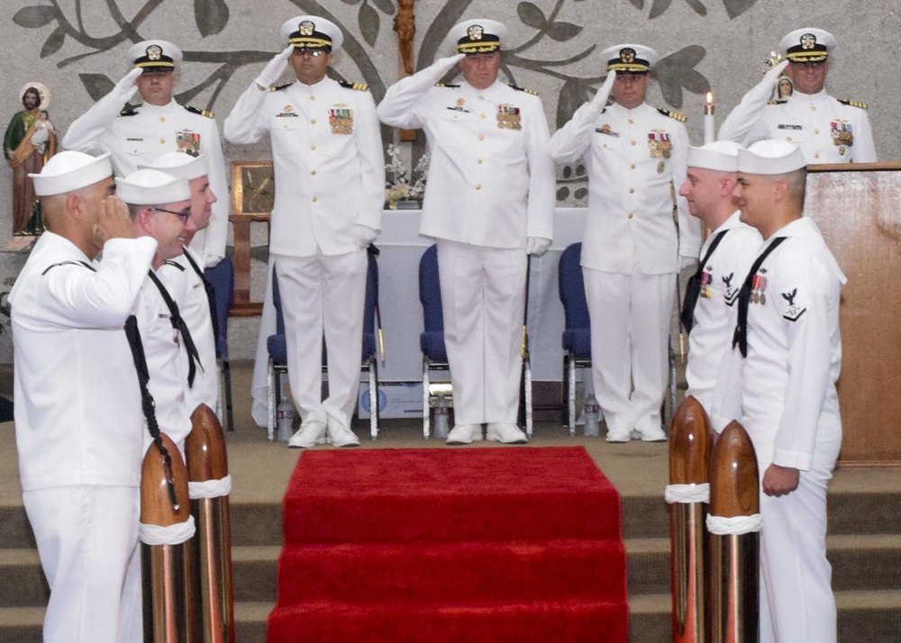 Sailors stand at attendion during the national anthem at the USS Topeka change of command