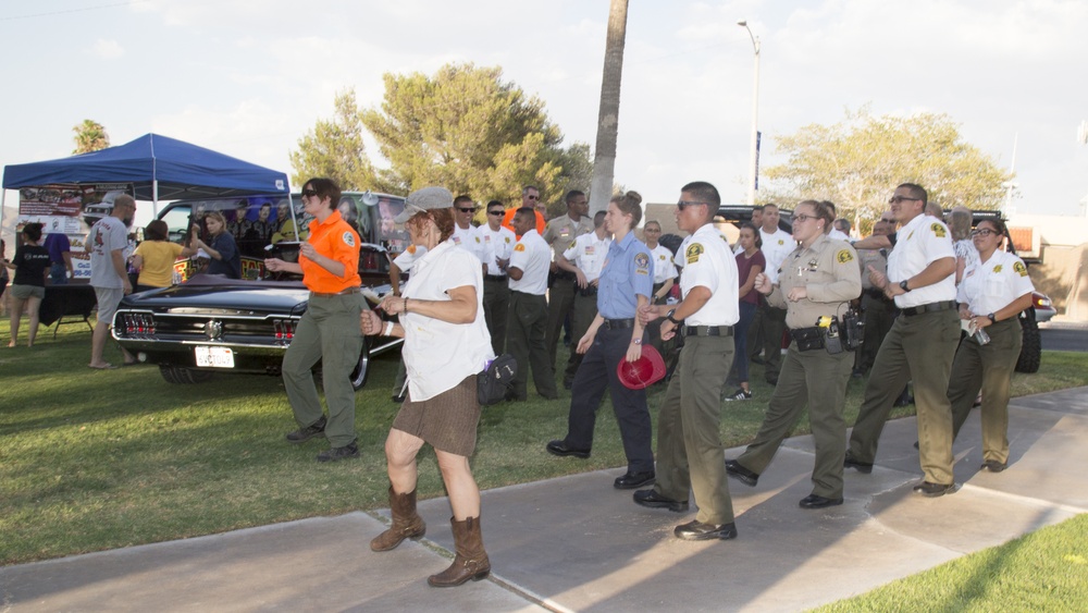 Cadets, Explorers, Law Enforcement Officers and Firefighters danced the Cupid Slide with local citizens during the National Night Out celebrations hosted by Barstow Police Department in Barstow, Calif., Aug. 2. The event was hosted by police departments n