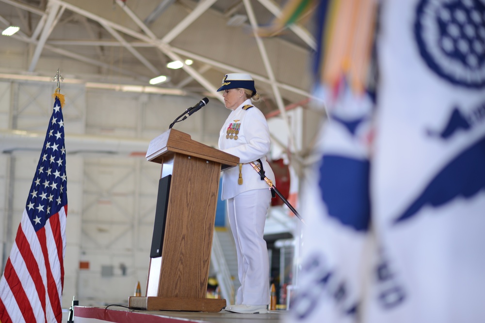 Capt. Carola J. List reads her orders assuming command of Coast Guard Air Station Sacramento