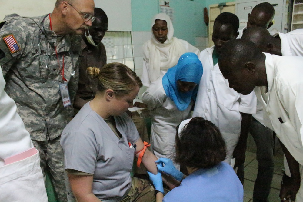 Army Reserve medical personnel demonstrate techniques for emergency room students in Chad hospital