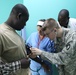 United States Military Academy cadet listens as Army Reserve nurse instructs in Chad hospital