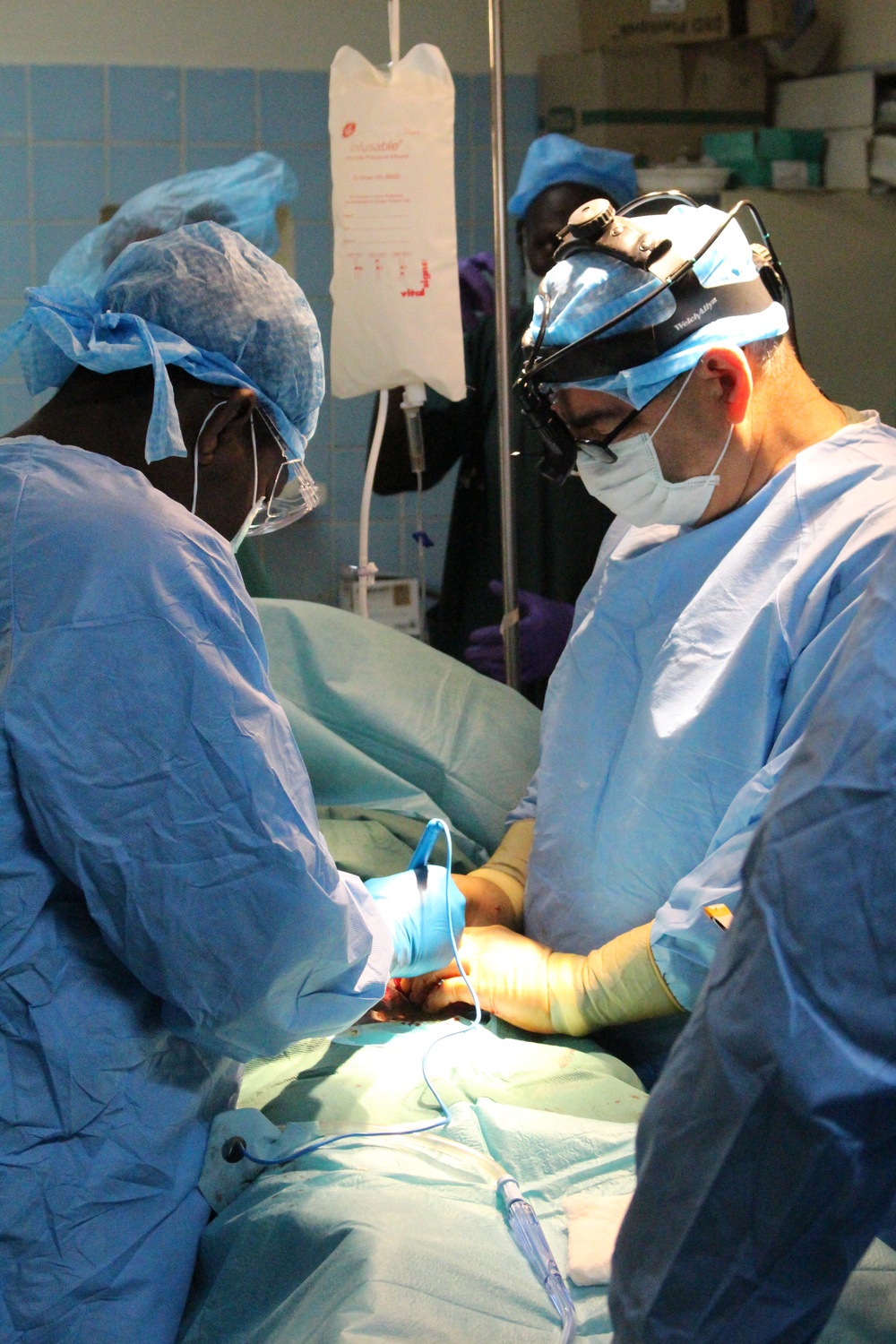 Chadian Army and Army Reserve surgeons work together to work on Chadian combat wounded in Chad hospital