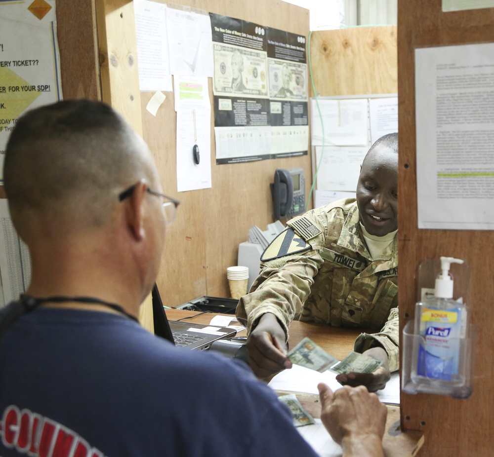 Soldier counts out cash overseas