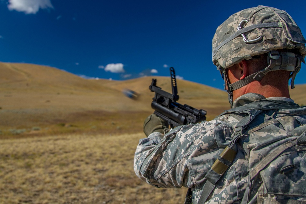 Sgt. 1st Class Joshua Moeller fire a M-320 grenade launcher