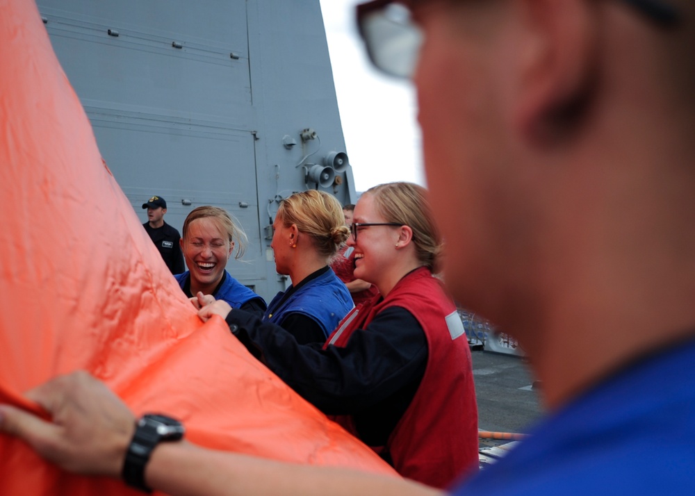 160811-N-LI612-152
PACIFIC OCEAN (August 11, 2016) Midshipmen laugh while preparing a killer tomato for a gun exercise on the flight deck aboard the Arleigh Burke-class guided-missile destroyer USS Shoup (DDG 86). Shoup is currently underway conducting ro