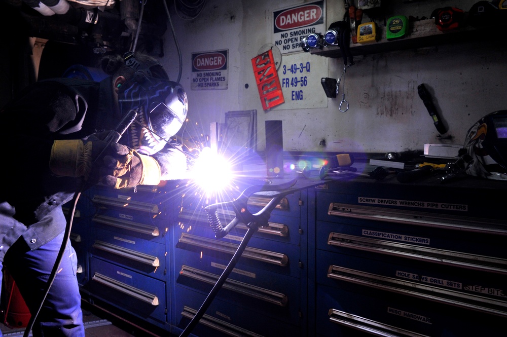 Coast Guard Damage Controlman fabricates parts for CGC Eagle while underway