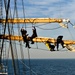Coast Guard Cutter Eagle crewmembers repair damaged sails while underway