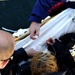 Coast Guard Cutter Eagle crewmembers repair damaged sails while underway