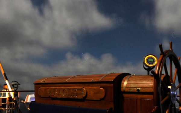 Coast Guard Cutter Eagle sails under a full moon