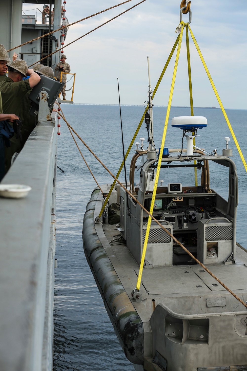 Shipmates aboard the SS Wright participate in experimental loading techniques