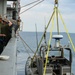 Shipmates aboard the SS Wright participate in experimental loading techniques