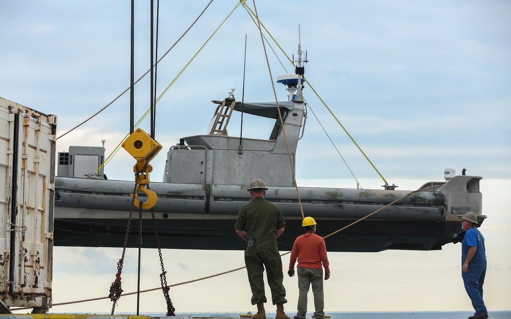 Shipmates aboard the SS Wright participate in experimental loading techniques