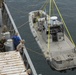 Shipmates aboard the SS Wright participate in experimental loading techniques