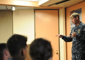 Commander, Submarine Squadron 11 speaks to midshipmen