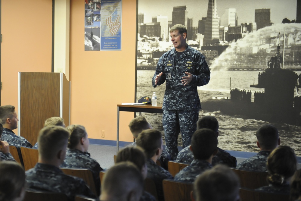Commander, Submarine Squadron 11 speaks to midshipmen