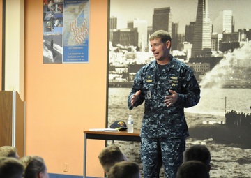 Commander, Submarine Squadron 11 speaks to midshipmen