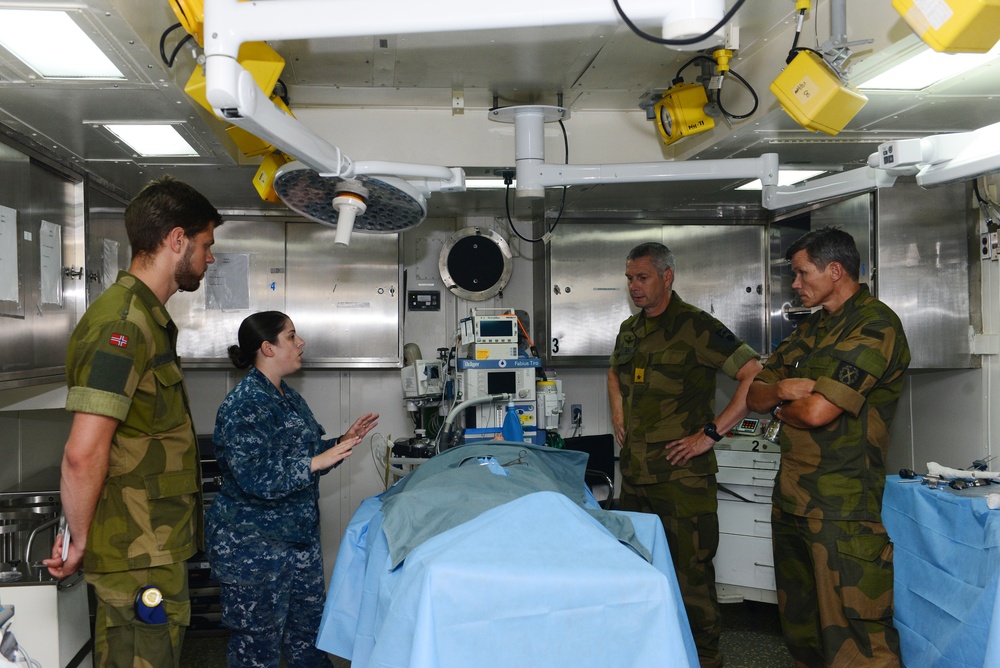 Hospital Corpsman 2nd Class Natasha N. Wetner explains shipboard medical capabilities to members of the Norwegian Army aboard the amphibious assault ship USS Bataan (LHD 5).