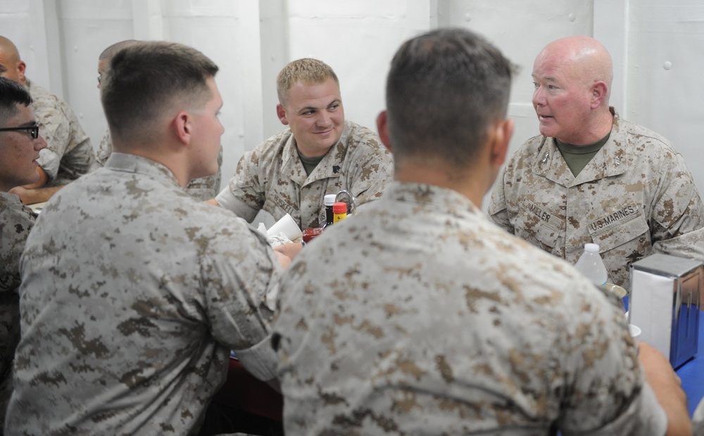 Maj. Gen. W. Lee Miller, Commanding General, II Marine Expeditionary Force, speaks with Marines during lunch on the mess decks of the amphibious assault ship USS Bataan (LHD-5).