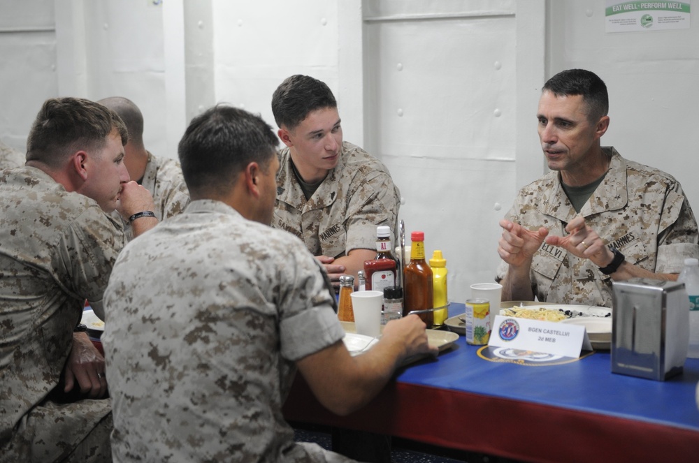 Brig. Gen. Robert F Castellvi, Deputy Commanding General speaks with Marines during lunch on the mess decks of the amphibious assault ship USS Bataan (LHD-5).
