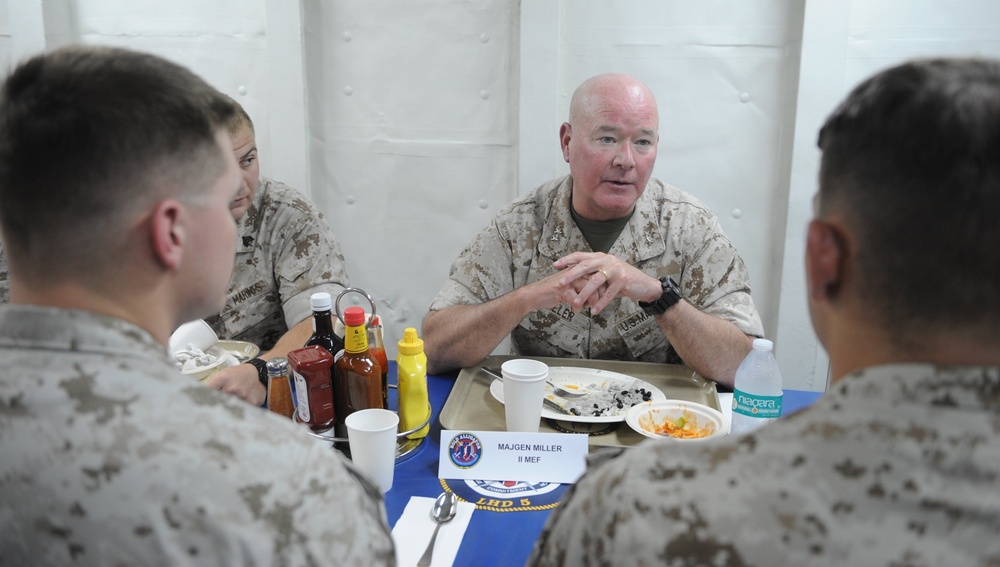 Maj. Gen. W. Lee Miller, Commanding General, 2 Marine Expeditionary Force, speaks with Marines during lunch on the mess decks of the amphibious assault ship USS Bataan (LHD-5).