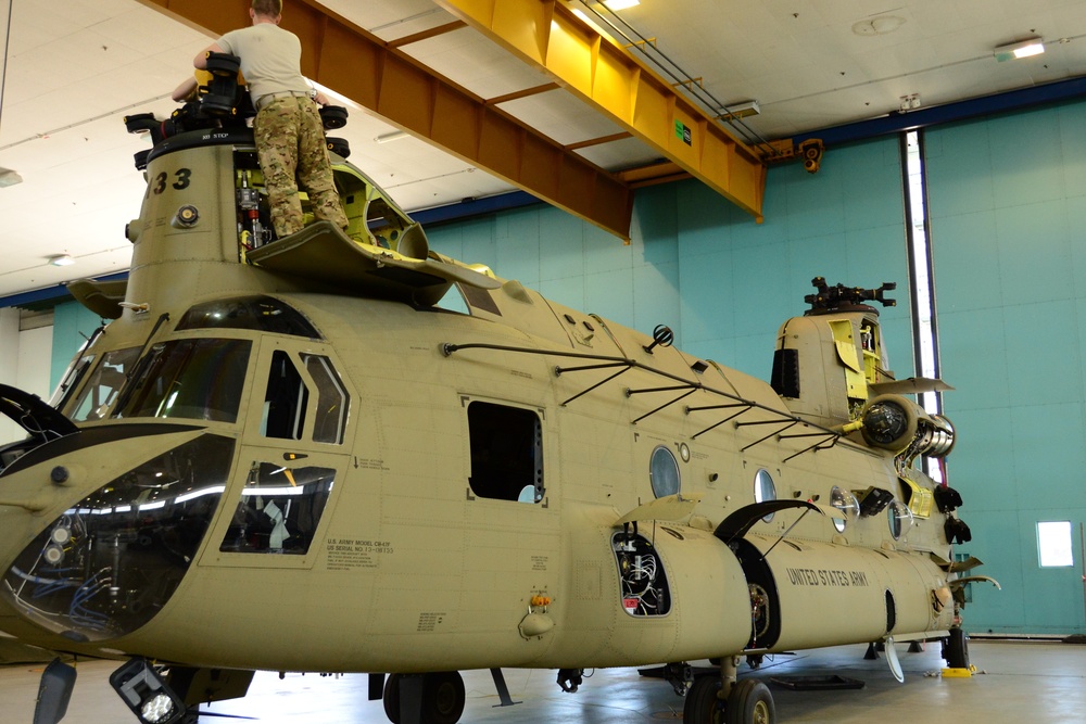 U.S. Army Air Crews conduct routine maintenance on a CH-47 Chinook