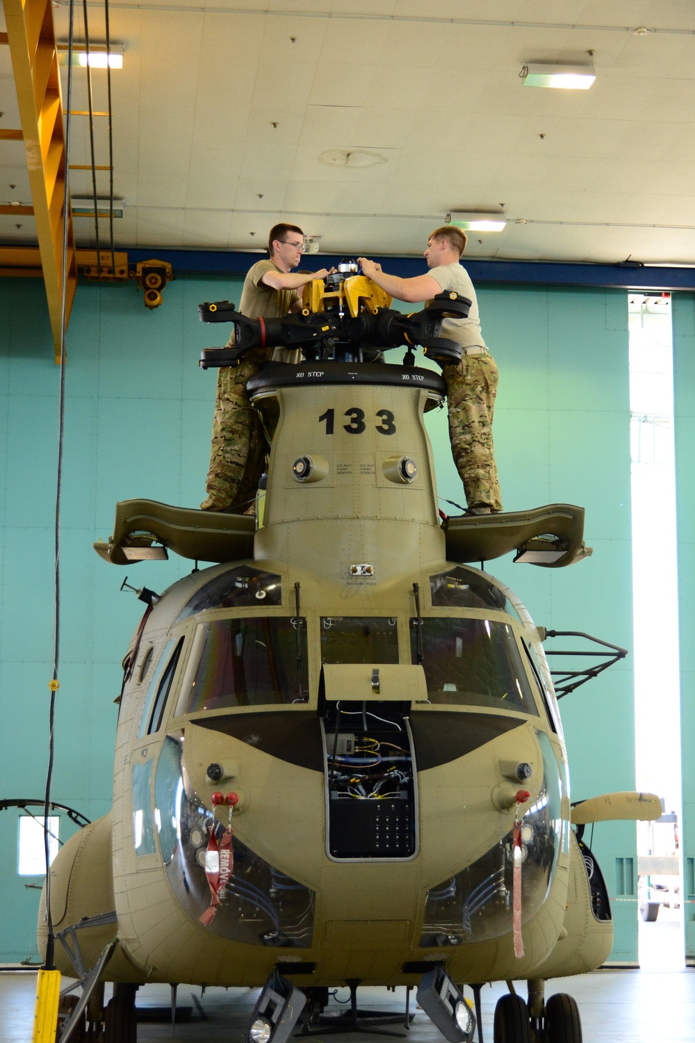 U.S. Army Air Crews conduct routine maintenance on a CH-47 Chinook