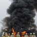Firefighters watch fuel-fire build