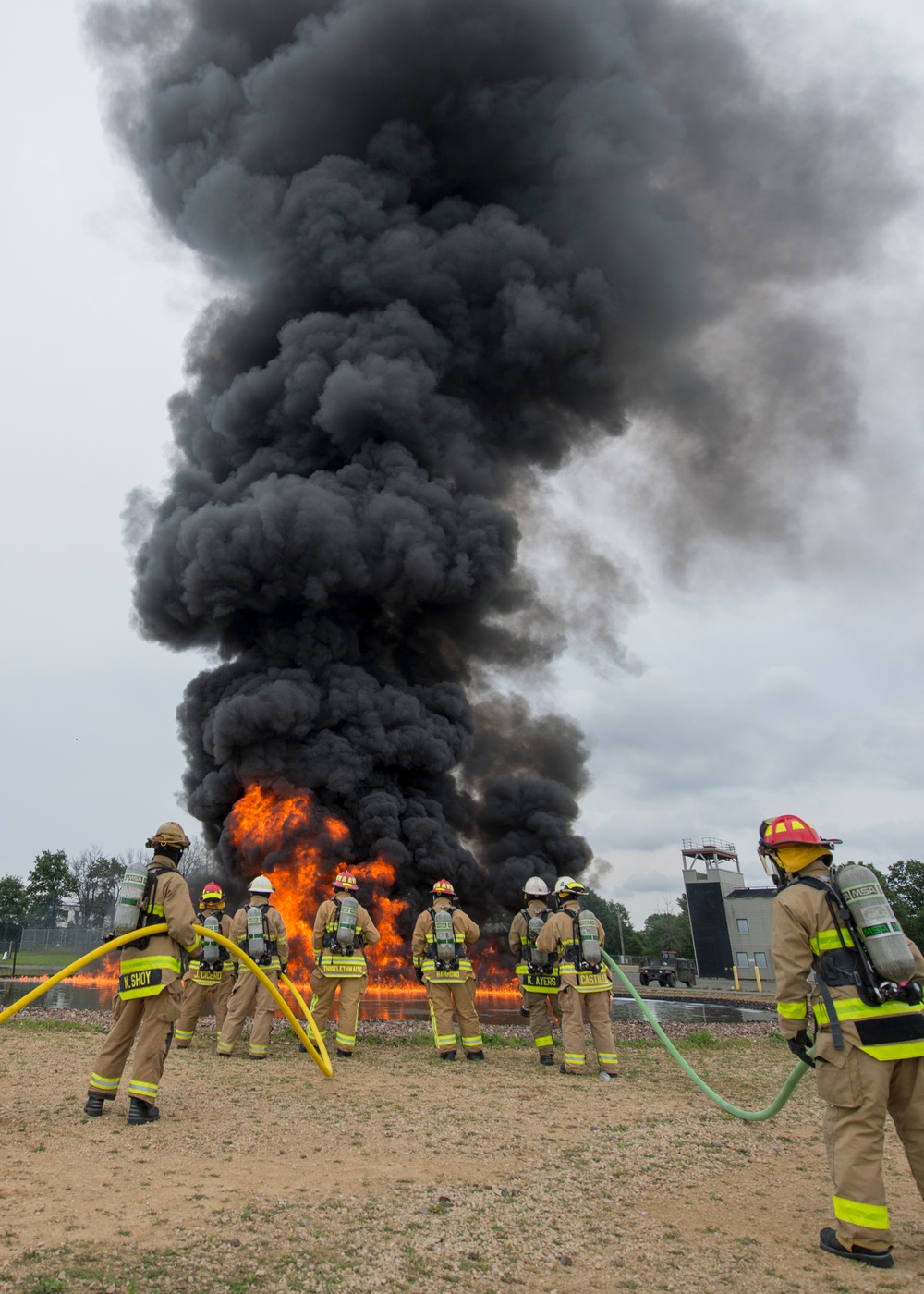 Firefighters watch fuel-fire build