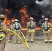 Firefighters watch fuel-fire build