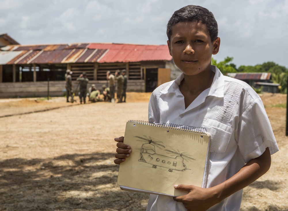 Honduran student poses with drawing he drew