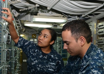 nformation Systems Technician 2nd Class Laura A. Hale, a Patuxent River, Md. native, and Electronics Technician 3rd Class Martin Rodriguez, a Nogales, Ariz. native, work together troubleshooting a high frequency receiver in the radio room aboard the amphi
