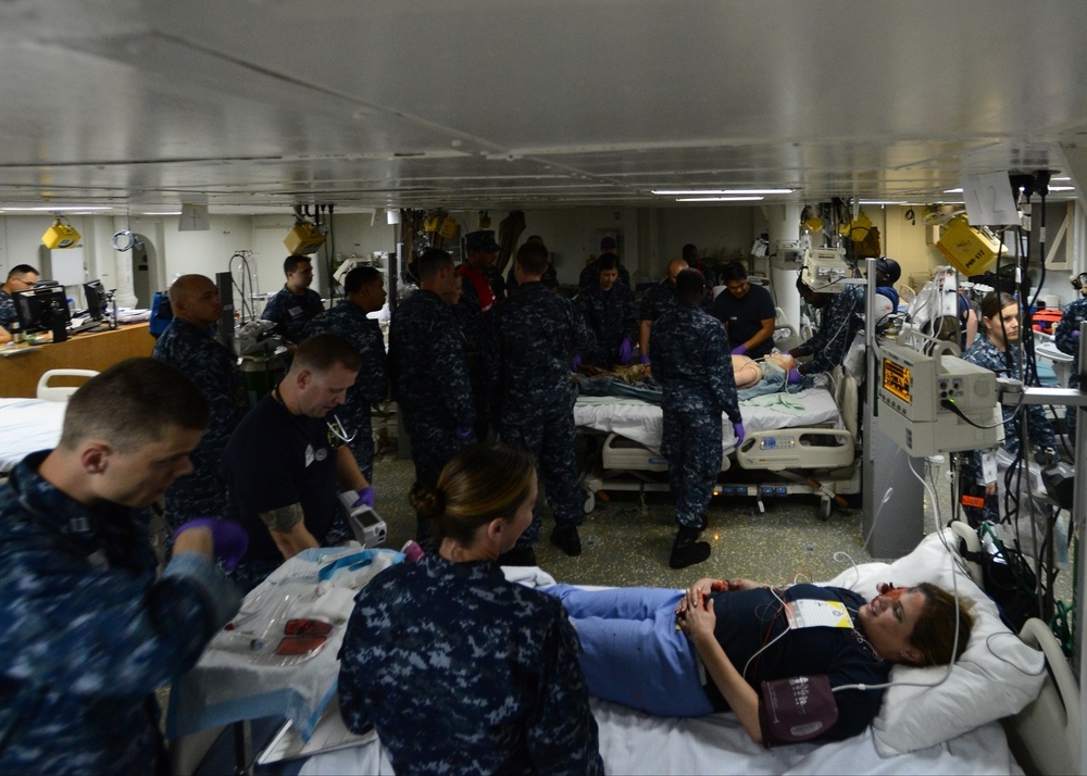 Sailors assigned to the amphibious assault ship USS Bataan (LHD 5), Fleet Surgical Team 6 and Naval Medical Center Portsmouth work together to give medical care to a simulated patient during a mass casualty drill in the intensive care unit aboard Bataan.
