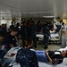 Sailors assigned to the amphibious assault ship USS Bataan (LHD 5), Fleet Surgical Team 6 and Naval Medical Center Portsmouth work together to give medical care to a simulated patient during a mass casualty drill in the intensive care unit aboard Bataan.