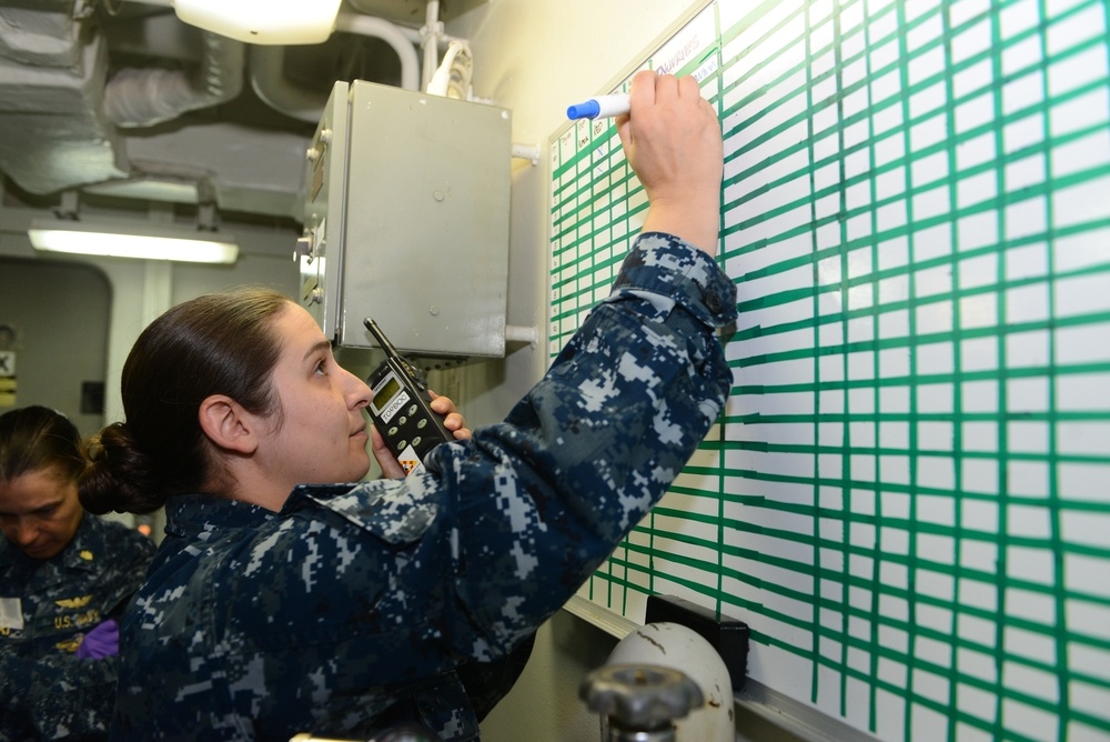 Hospital Corpsman 1st Class Ashley Gibson writes injury statuses on a white board in medical triage aboard the amphibious assault ship USS Bataan (LHD 5).