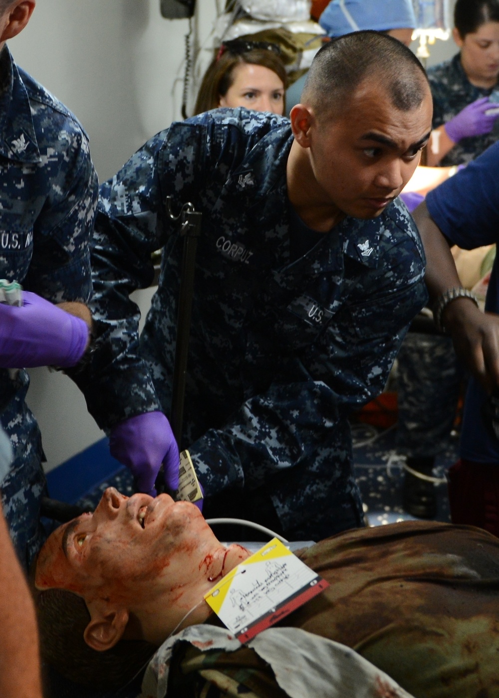 Hospital Corpsman 2nd Class Kirk Corpuz gives medical care to a simulated patient in medical triage of the amphibious assault ship USS Bataan (LHD 5).