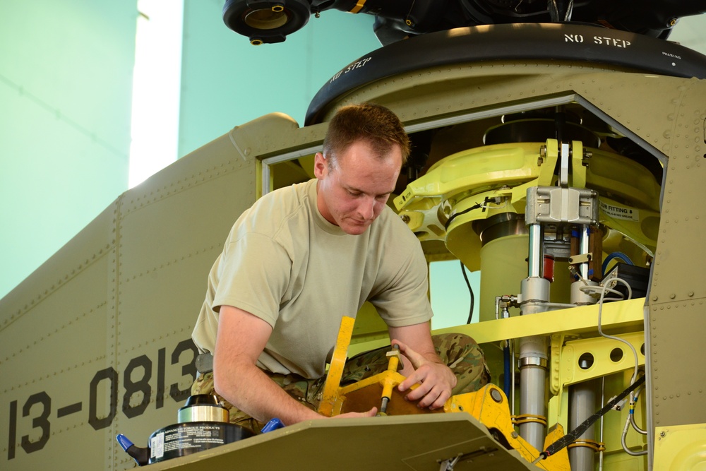 Soldier working on Chinook rotor head section