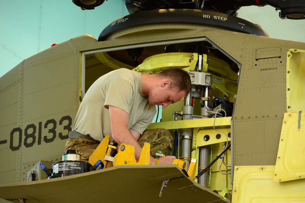 U.S. Army Air Crews conduct routine maintenance on a CH-47 Chinook