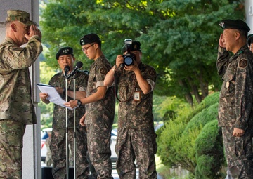 General salutes general