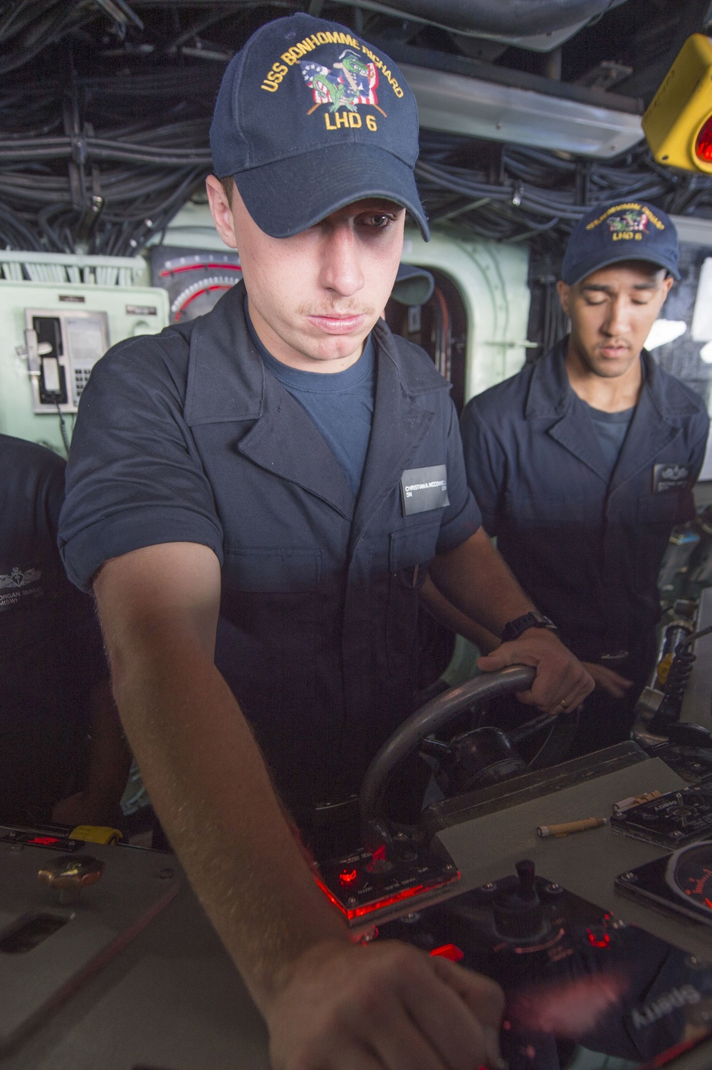 Sailor mans the helm on the bridge aboard USS Bonhomme Richard (LHD 6)