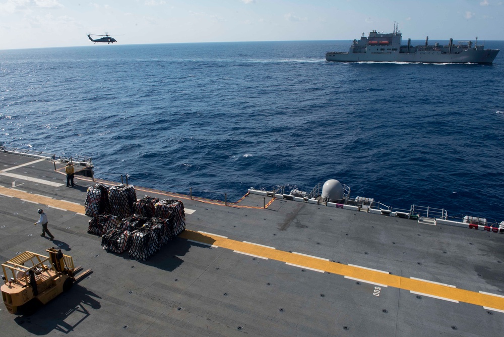 Marines move supplies during vertical replenishment.