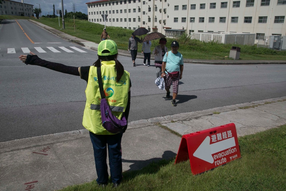 Okinawa residents participate in a tsunami evacuation drill aboard Camp Foster