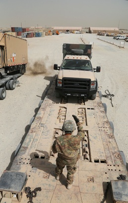 PFC guides truck onto trailer