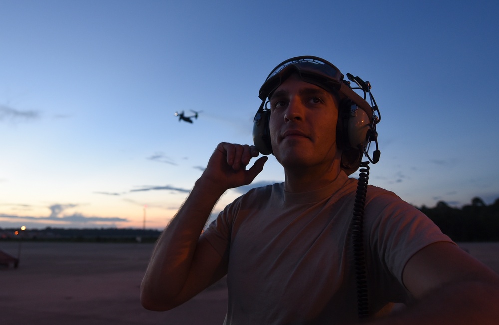 Crew chiefs guide in a CV-22B Osprey