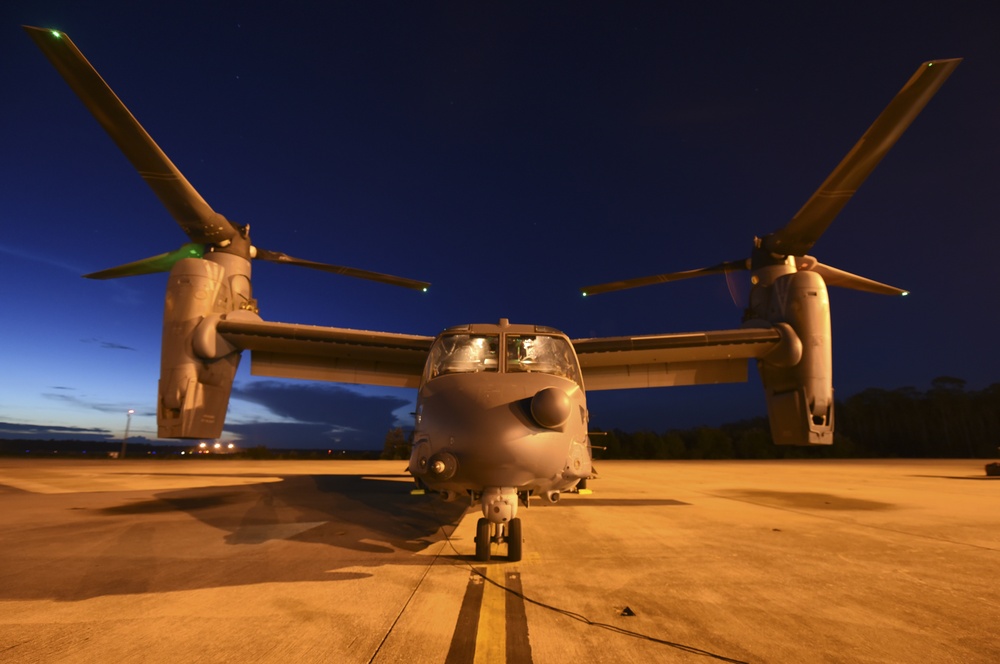 Crew chiefs guide in a CV-22B Osprey