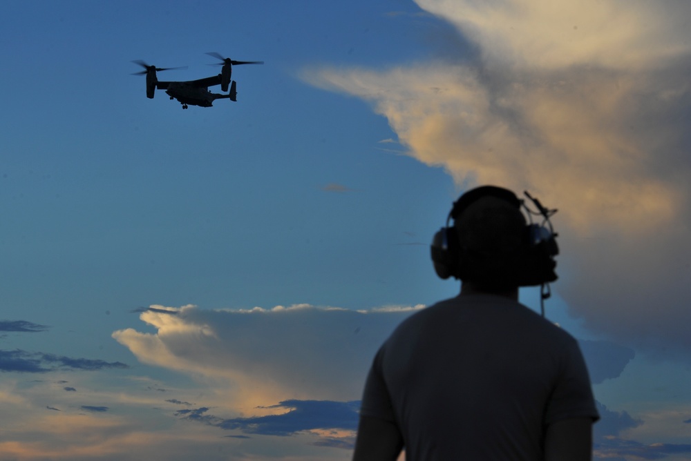 Crew chiefs guide in a CV-22B Osprey