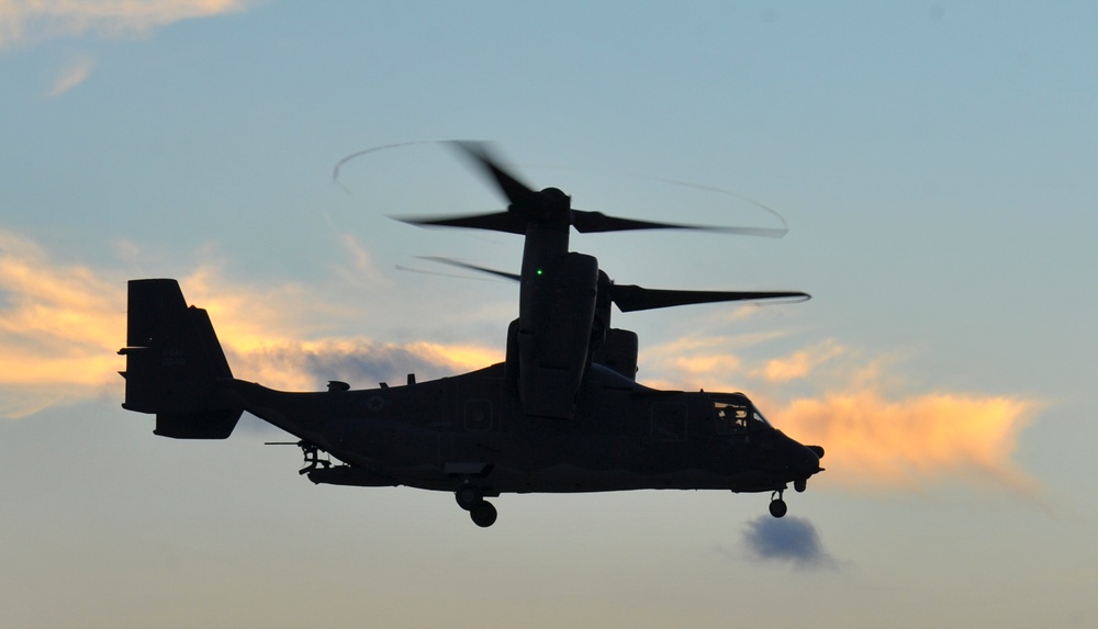 Crew chiefs guide in a CV-22B Osprey